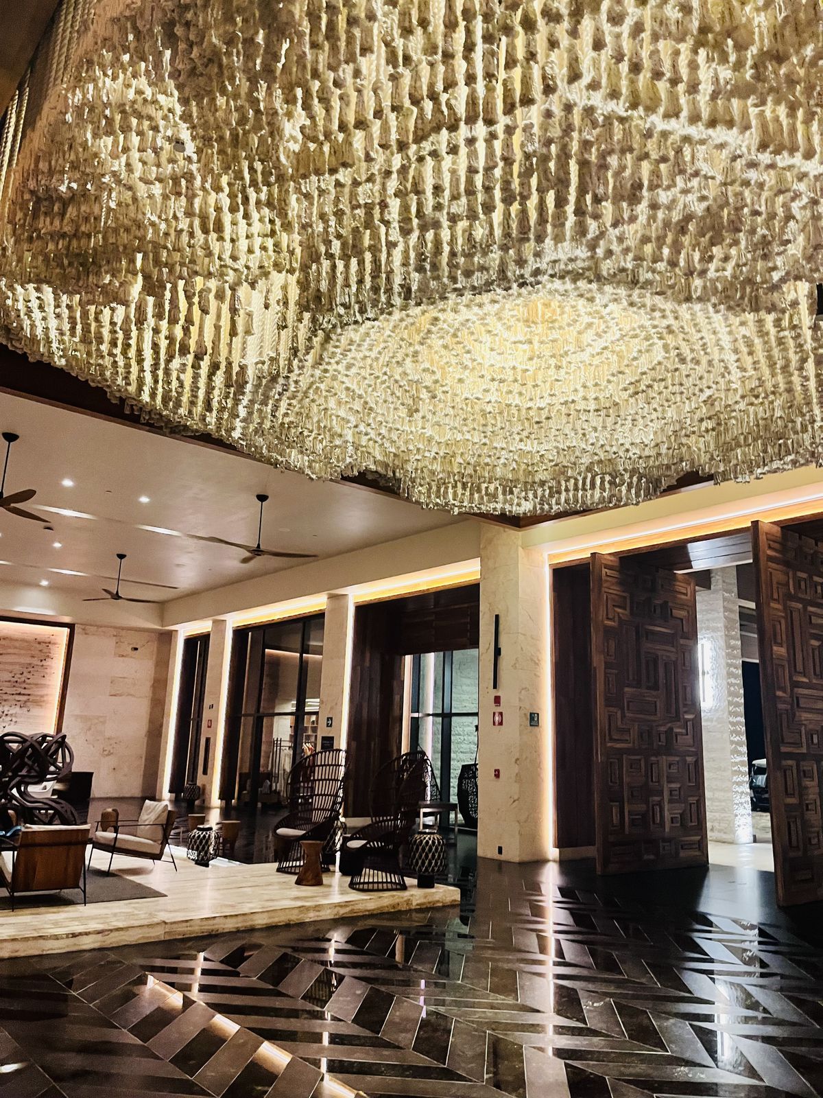 A huge woven chandelier in a hotel lobby