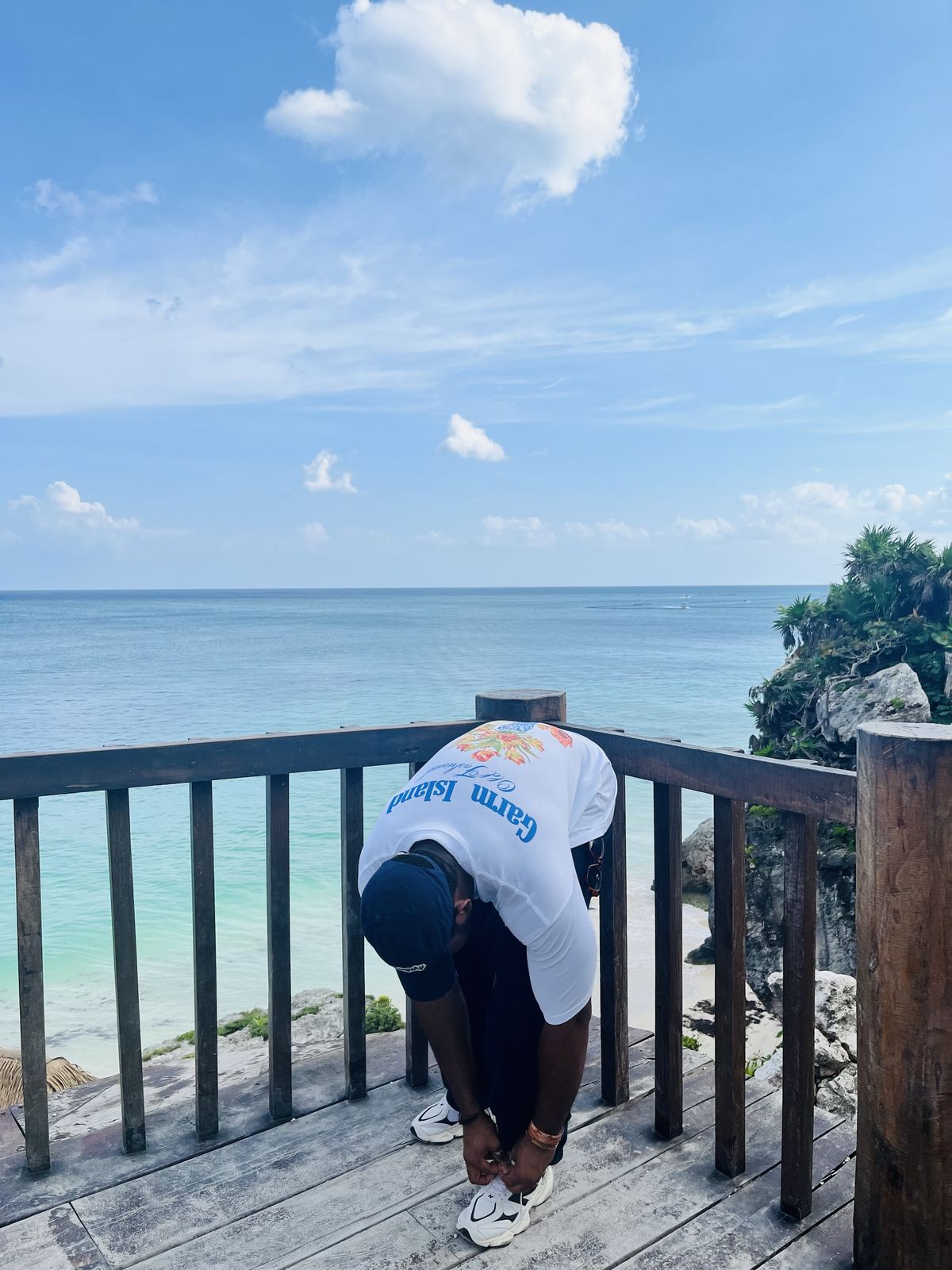 OJ leaning on a railing above the Caribbean