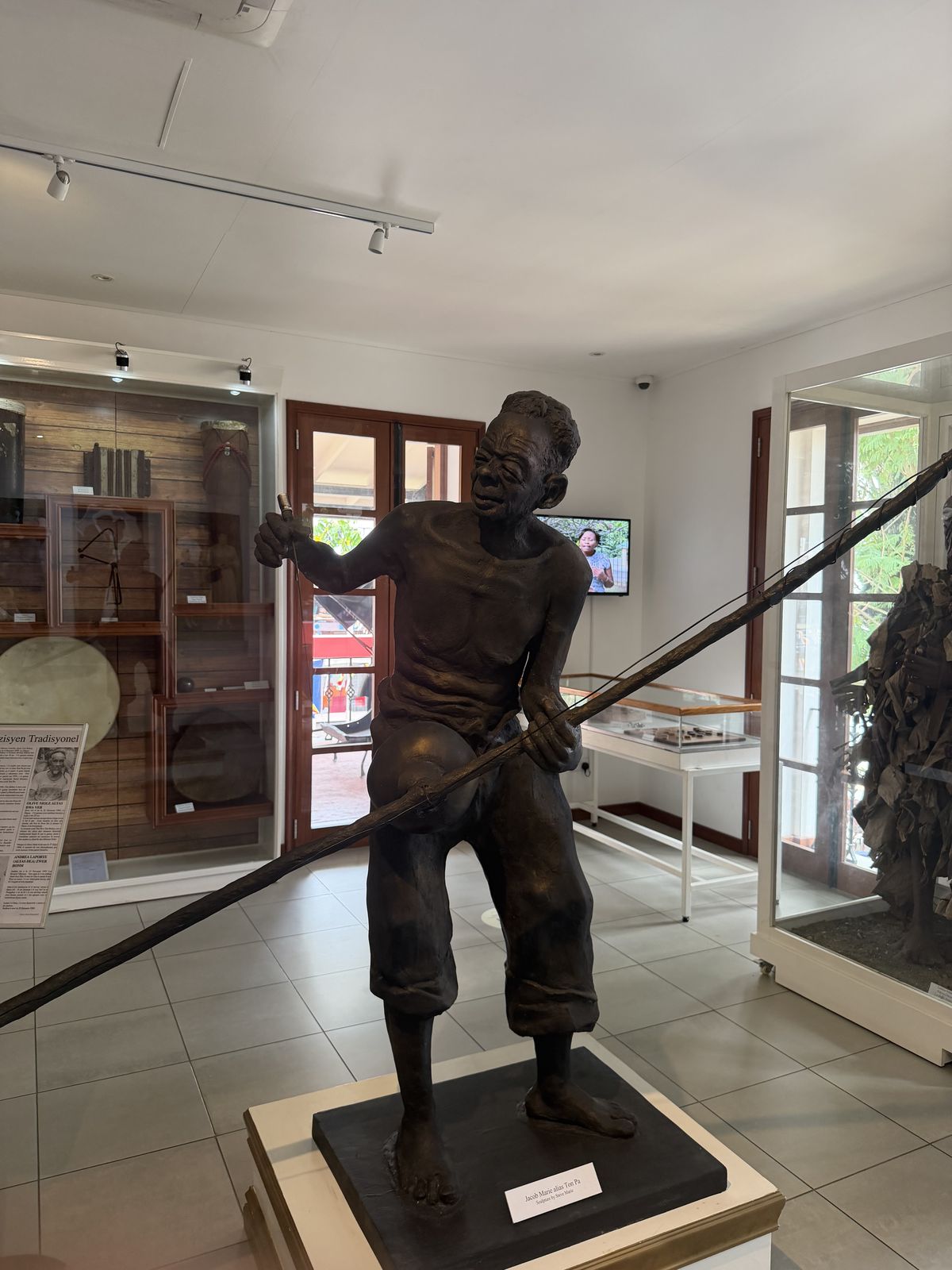 A bronze statue of a labourer inside a museum in Victoria