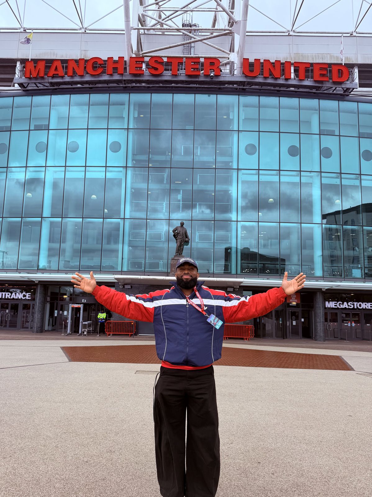 OJ with arms wide outside Old Trafford, Manchester United's stadium